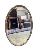 A 19th century oval wall mirror with bead border, width 91cm, height 66cm