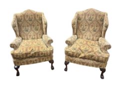 A pair of George III style upholstered wing armchairs, width 86cm, depth 74cm, height 120cm