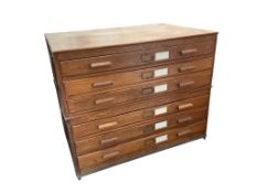 A 1930's light oak plan chest in two sections, width 113cm, depth 82cm, height 92cm