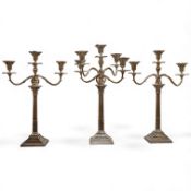 A garniture of 19th century silver plated Corinthian column candelabra, comprising a pair of two bra