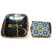 A 19th century pottery slipware baking dish (restored), 34cm wide and a Spanish maiolica tile