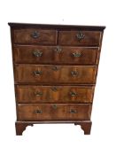 An early 18th century feather banded walnut and pine two section chest of drawers, on later bracket