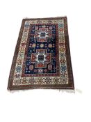 A Caucasian Kazak blue ground geometric rug, 128 x 80cm