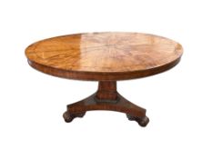 A George IV oval satinwood tilt top dining table (a.f.), width 144cm, depth 112cm, height 74cm
