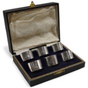 A cased set of six George V Irish silver napkin ring's, each engraved with a dear and harp on a rock