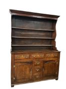An early 18th century North Wales oak dresser, with boarded rack, width 144cm, depth 52cm, height 19