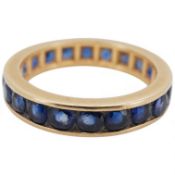 A yellow metal and sapphire set full eternity ring, size L, gross 3.3 grams.
