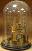 A mid 19th century brass monocular microscope, unsigned, with five objectives and three eyepieces,