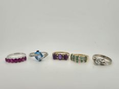 Three assorted modern 9ct gold and gem set rings, to include emerald and diamond cluster, blue topaz