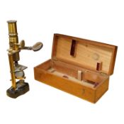 A late 19th/early 20th century French brass compound monocular microscope, height 20.5cms,