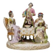 A 19th century Dresden porcelain group of three figures at a table, 24cm high