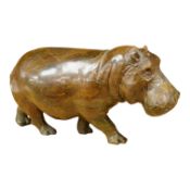 A carved serpentine study of a walking hippopotamus, incised initials to the underside 'E.S.',