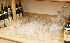 A collection of Webb cut glass suites and four decanters, together with a glass jug, largest 35cm