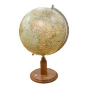 A mid 20th century 12 inch terrestrial globe on an oak base with integrated compass, the globe