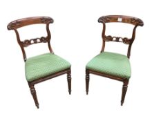 A pair of William IV rosewood dining chairs, with foliate carved decoration to the back supports,
