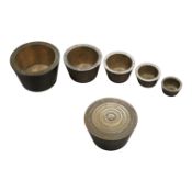 Two sets of bronze Troy nesting weights, one incomplete, with engraved rims, largest 8oz