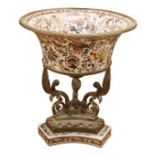 An early 20th century enamelled porcelain and ormolu mounted centrepiece with tripod scroll base,