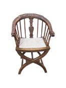 An Italian carved walnut 'X' frame elbow chair, width 58cm, depth 43cm, height 88cm