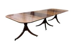 A Regency style mahogany and satinwood banded three pillar dining table, width 320cm extended, two