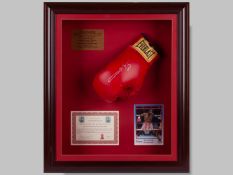 A red leather boxing glove signed by Sugar Ray Leonard