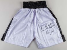 Pair of black and white Iron Mike Tyson autographed boxing trunks.