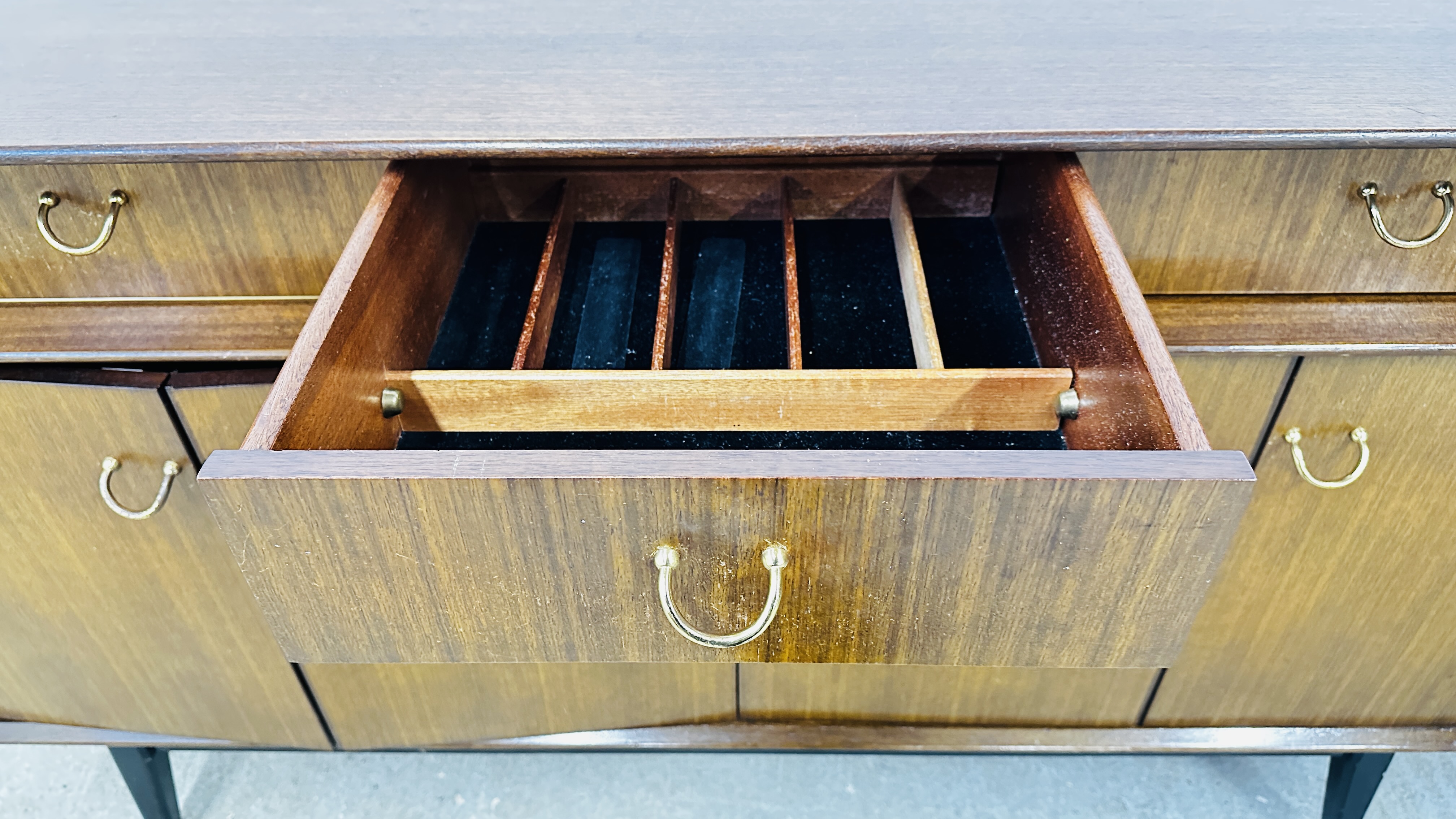 A MID CENTURY G PLAN E-GOMME SIDEBOARD, THE THREE RAISED DRAWERS ABOVE TWO BI-FOLD DOORS. - Image 18 of 19