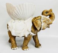 A LARGE GLAZED POTTERY STUDY OF A STANDING ELEPHANT H 60CM X L 67CM.