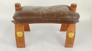 A VINTAGE LEATHER SEAT CAMEL STOOL.