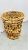 WICKER AND RUSH WOVEN LAUNDRY BASKET.