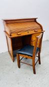 AN ANTIQUE CHILD'S ROLL TOP DESK AND CHAIR W 77 X D 47 X H 82CM.