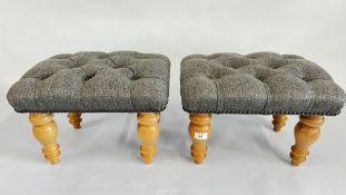 A PAIR OF MODERN FOOTSTOOLS WITH GREY BUTTON BACK UPHOLSTERY.