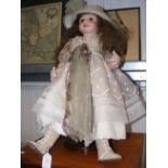 A reproduction doll on stand