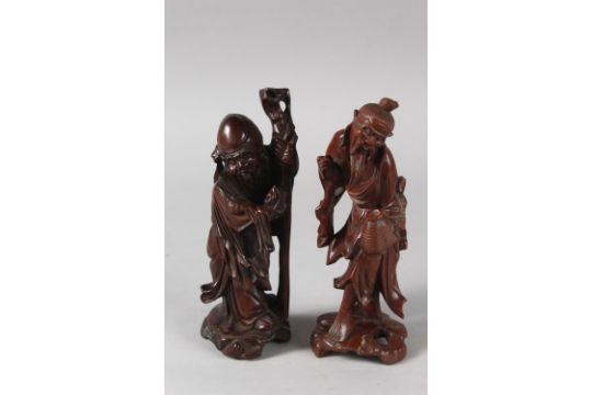 TWO 19TH CENTURY CHINESE CARVED WOOD FIGURES, each approx. 21cm high. - Image 1 of 2