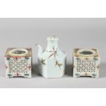 TWO PIERCED OPENWORK PORCELAIN SQUARE-FORM POTS, together with a porcelain hexagonal lidded water