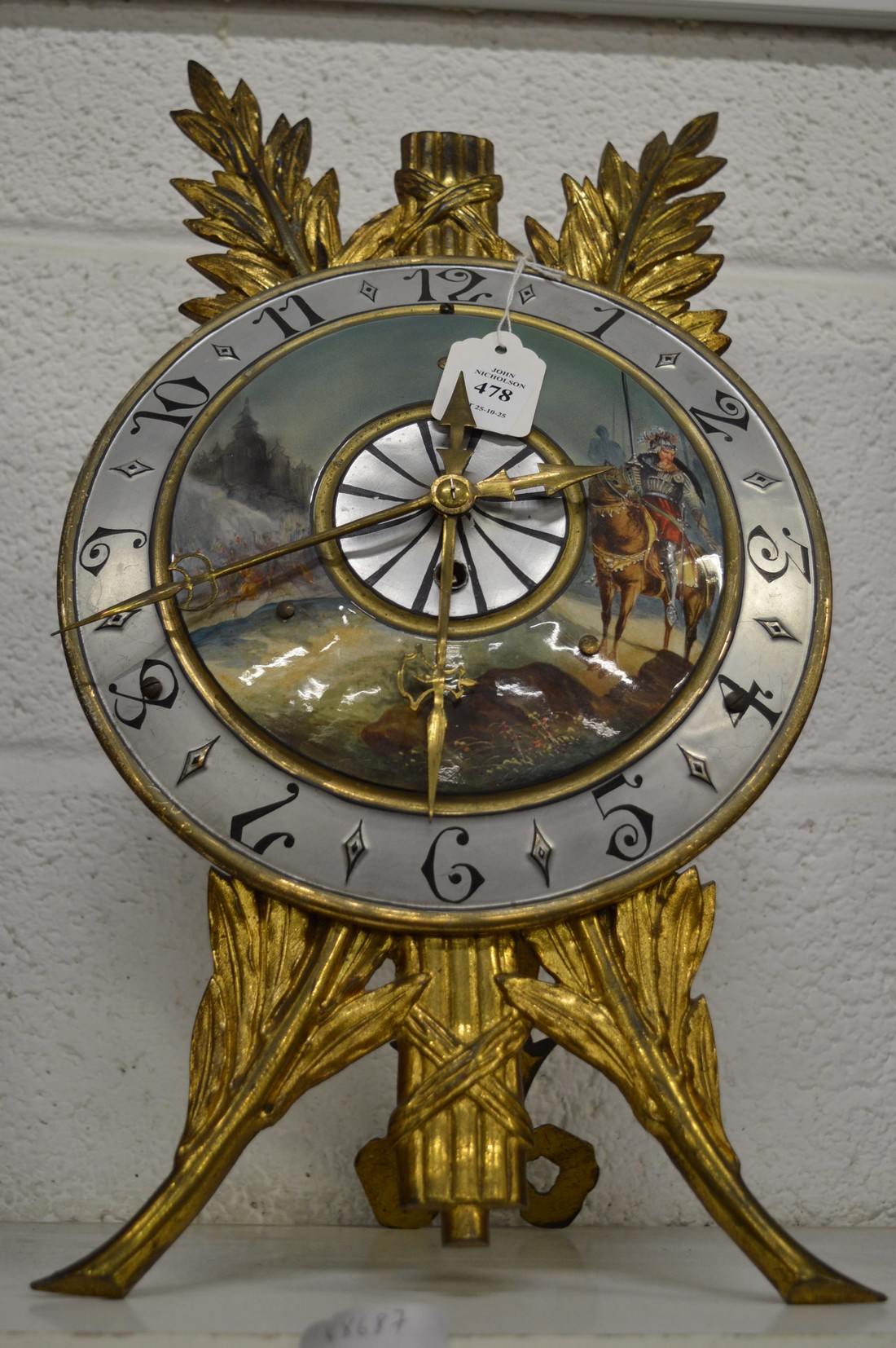 A decorative cast metal strut clock with painted dial.