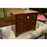 A miniature Georgian style three drawer chest opening to reveal an early radio.