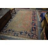 Persian rug, pink ground with stylised decoration, worn, 295cm x 186cm.