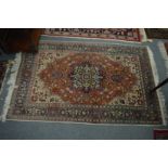 A Persian rug, rust ground with floral decoration, 162cm x 103cm.