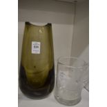 A smoky glass vase and a tankard engraved with a sailing boat.