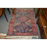 A Persian rug, blue ground with geometric decoration, 150cm x 110cm.