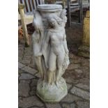 A reconstituted stone figural bird bath support.