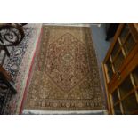 A Persian rug, beige ground with stylised decoration, 163cm x 92cm.