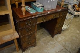 A reproduction pedestal desk.