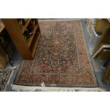 A Persian rug, blue ground with floral decoration, 215cm x 140cm.