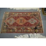A small Persian rug, 135cm x 80cm.
