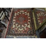 A Persian rug, red ground with stylised decoration, 143cm x 102cm.