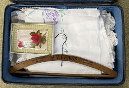 Small suitcase containing table cloths & other linen etc