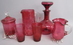 Cranberry glass includes decanter, water jug and glasses, lidded pot and flare rimmed cup / jug
