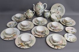 Chinese tea set with hand painted flower decoration comprising teapot with bamboo design handle,