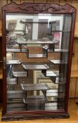 Chinese hardwood display cabinet with a mirrored back. Ht 84cm W 53cm D 12cm